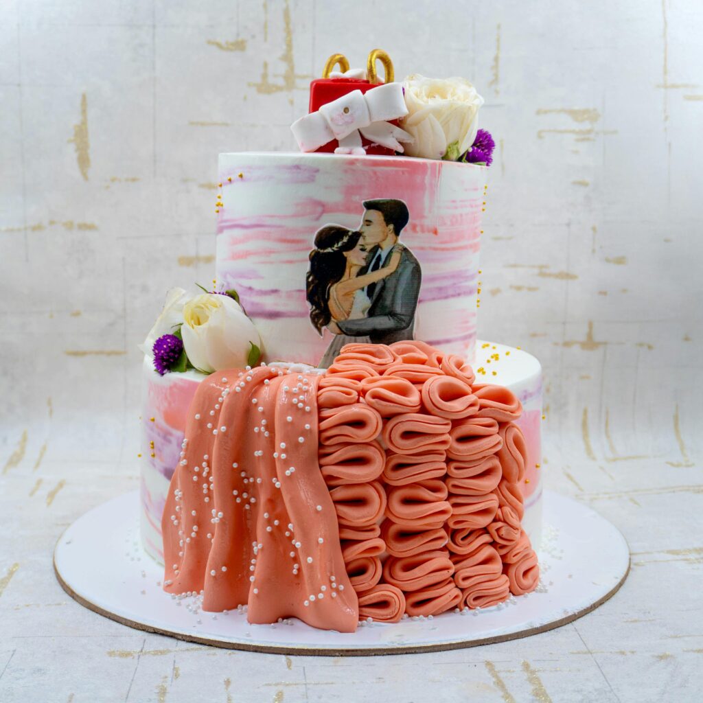 A beautifully decorated wedding cake featuring floral elements and a painted couple in embrace.